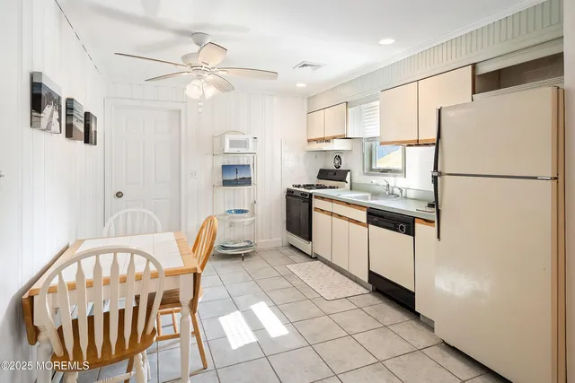 a kitchen with stainless steel appliances granite countertop a sink and a refrigerator