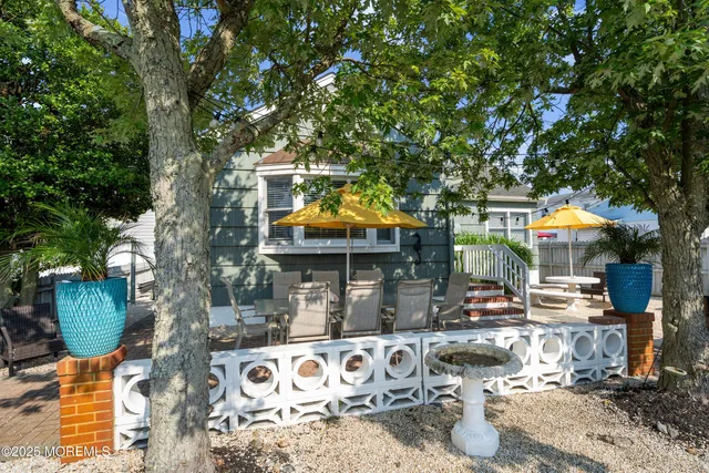 a patio with a yard table and chairs