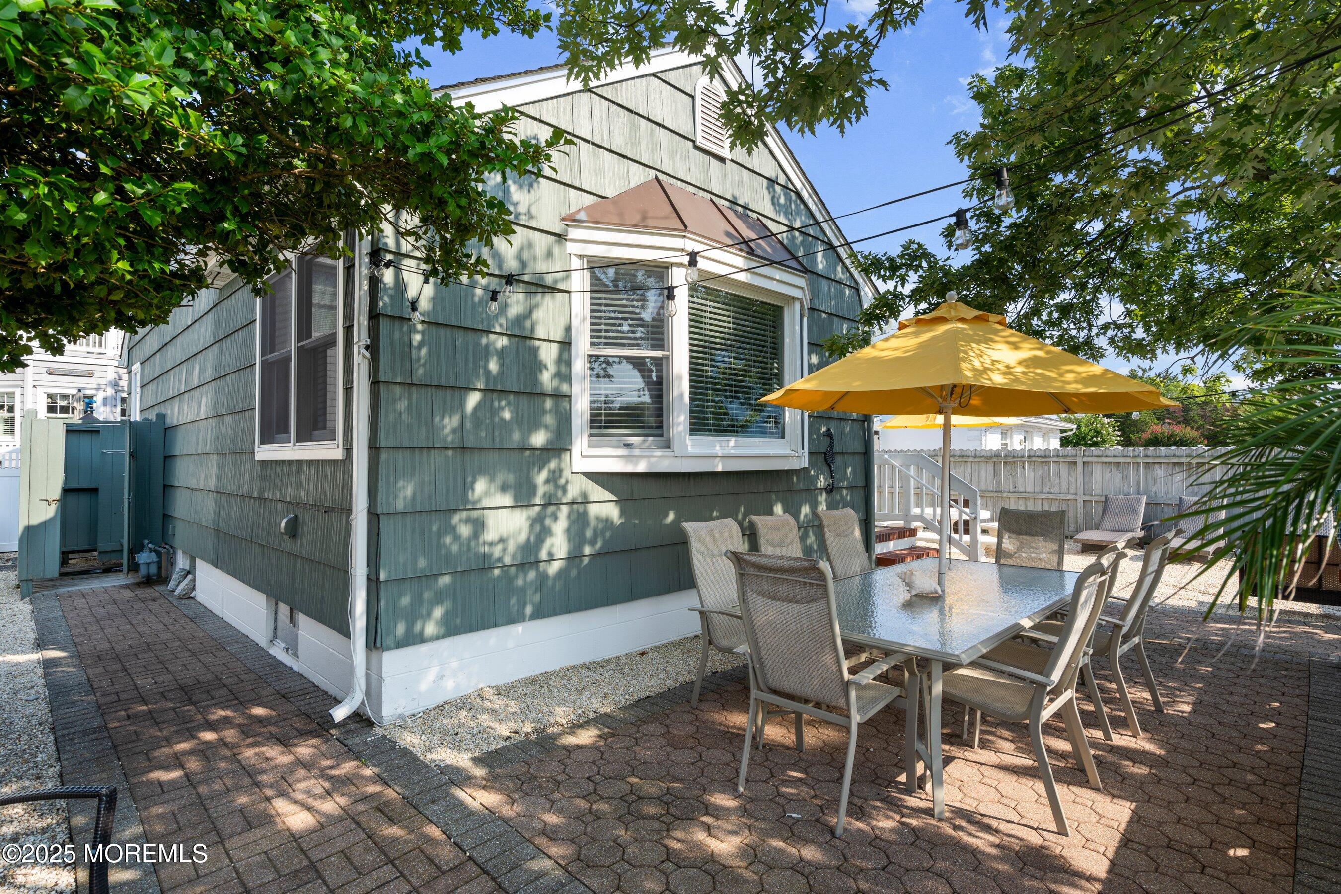 2003 Bay Boulevard Lavallette, NJ 08735 - Photo 4 of 31 a patio with a yard table and chairs