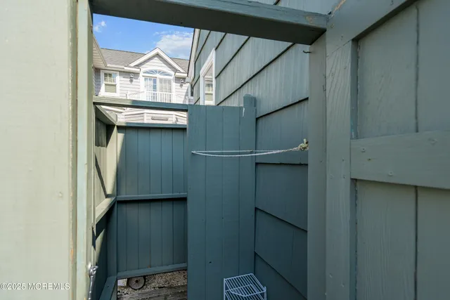 a view of backyard with outdoor seating and wooden fence