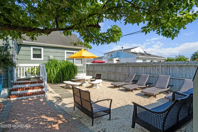a backyard of a house with table and chairs