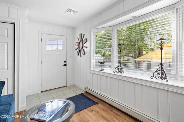a living room with furniture a ceiling fan and a window