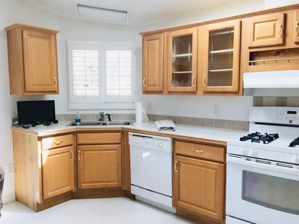2602 Green Street Middleboro, MA 02346 - Photo 4 of 25 a kitchen with granite countertop white cabinets and white appliances