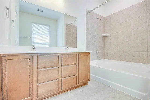 a bathroom with a bathtub and a sink