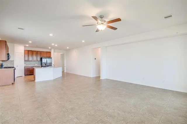 a view of a kitchen with a sink and a refrigerator