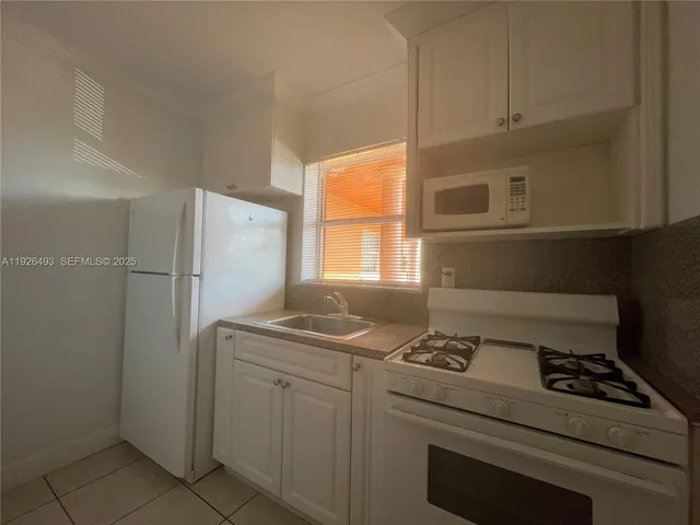 a kitchen with a stove microwave and refrigerator