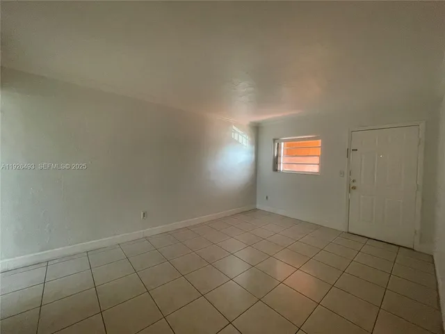 a view of an empty room and window