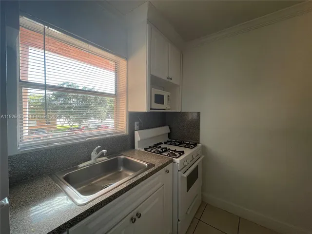 a kitchen that has a sink and a window