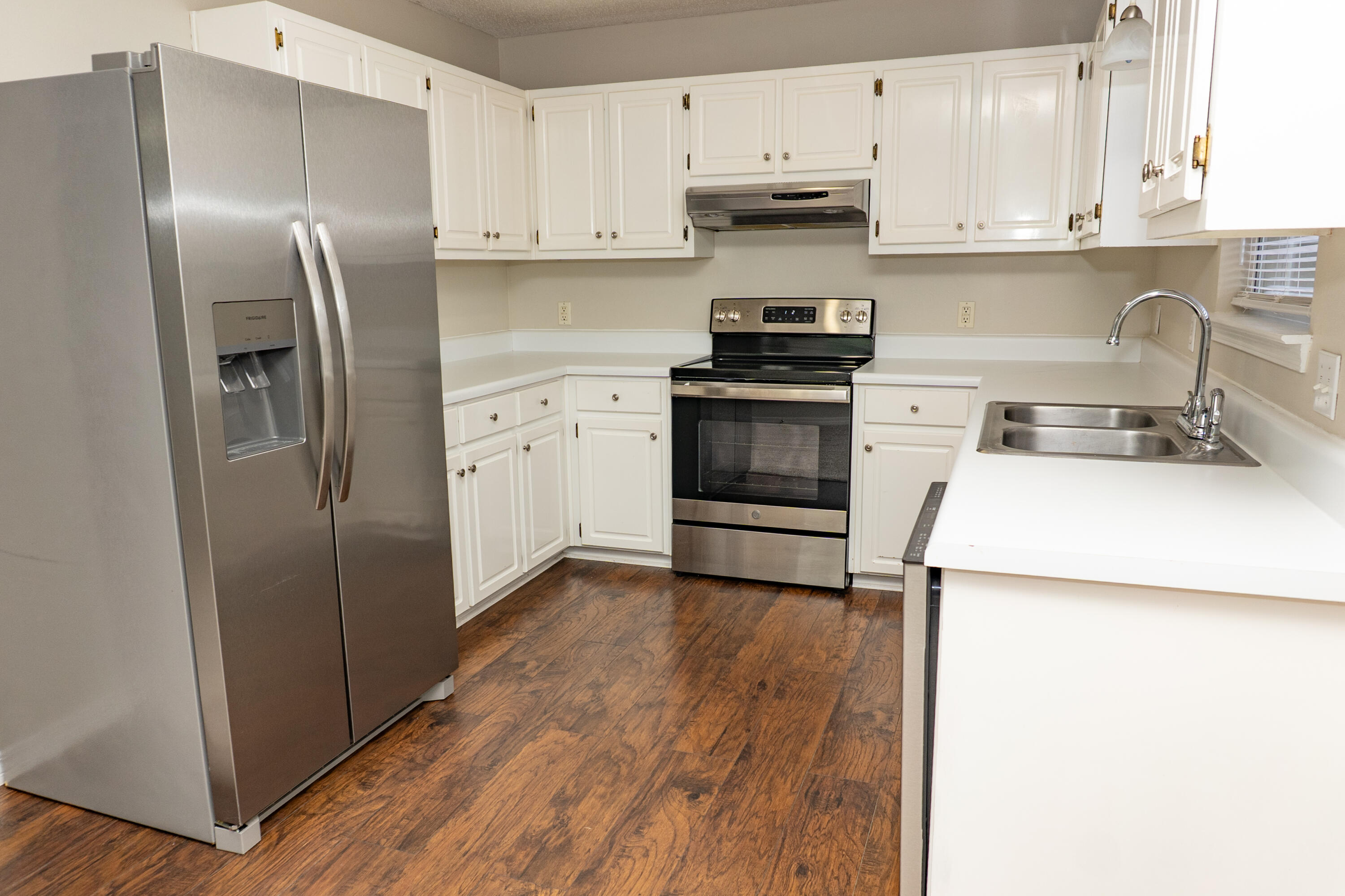 5136 Whitehurst Lane Crestview, FL 32536 - Photo 2 of 24 a kitchen with a refrigerator sink and cabinets