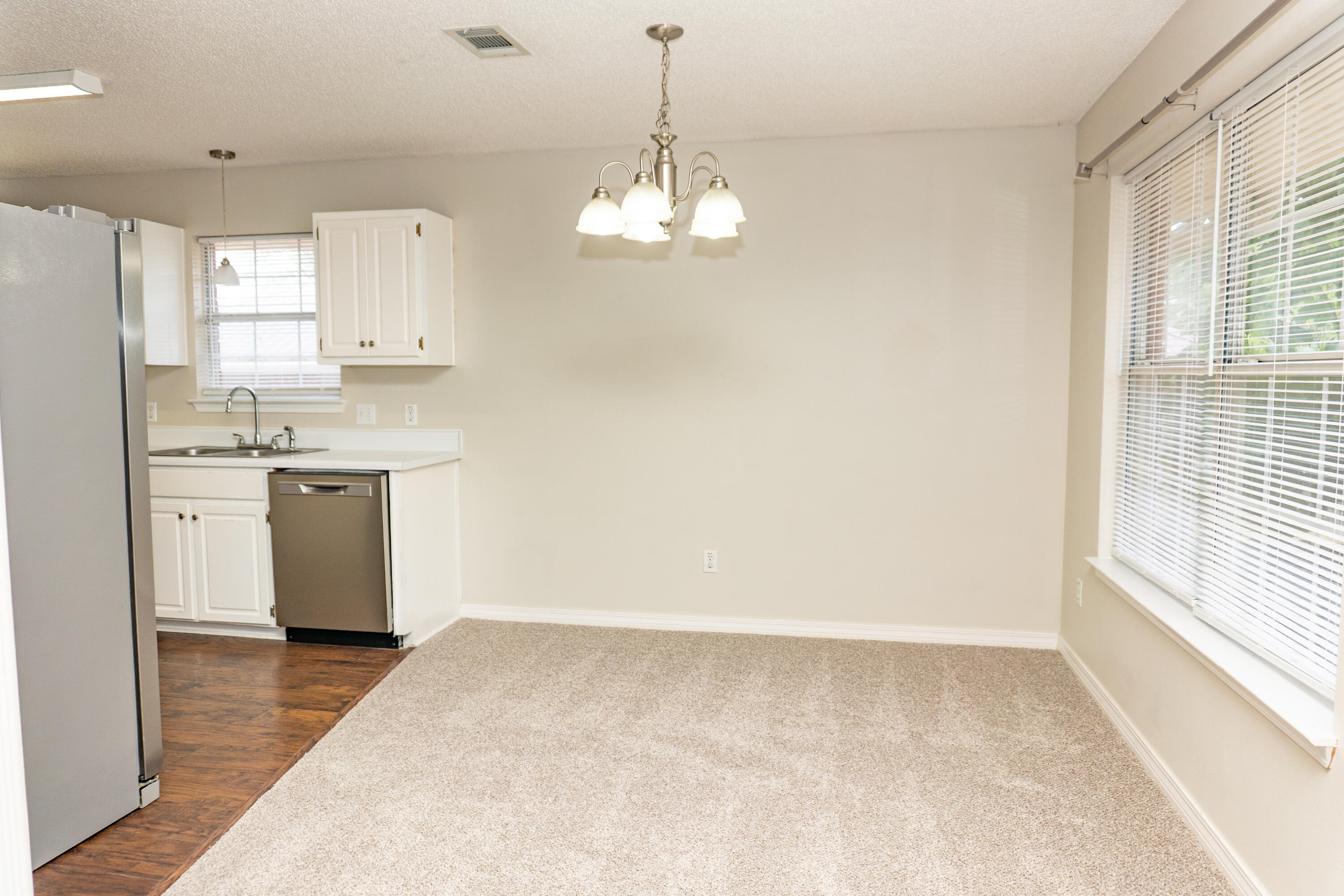 5136 Whitehurst Lane Crestview, FL 32536 - Photo 4 of 24 a kitchen with a stove a sink a window and cabinets