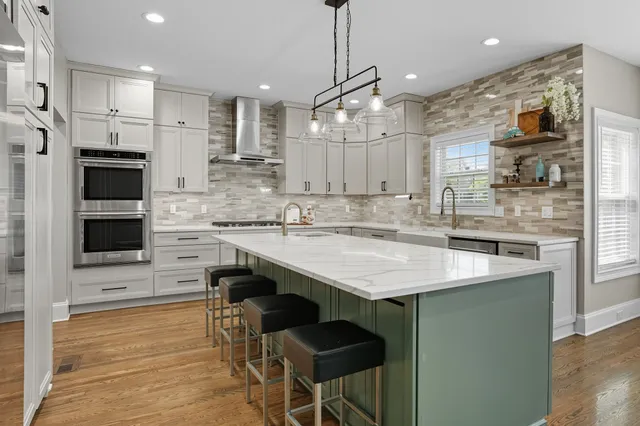 a front view of a house with a yard and trees