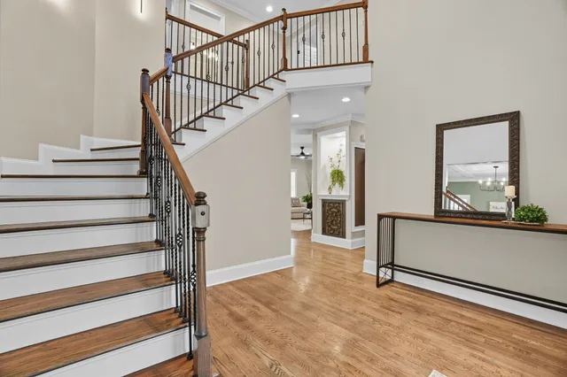 a living room with furniture a ceiling fan and a bookshelf