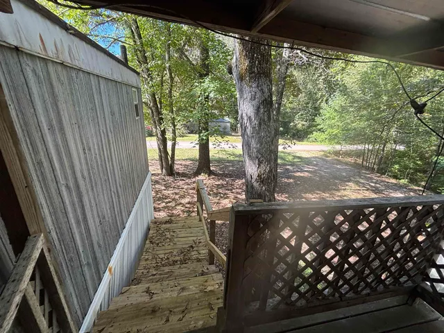 a view of a yard with wooden fence