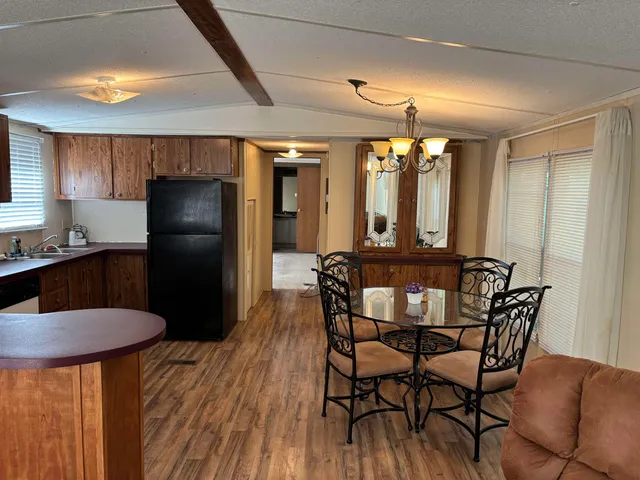 a view of a dining room with furniture and window