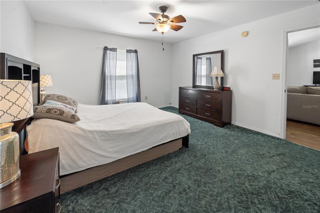 1750 Southwest 15th Street Bell, FL 32619 - Photo 12 of 34 a bedroom with a bed dresser and a flat tv screen