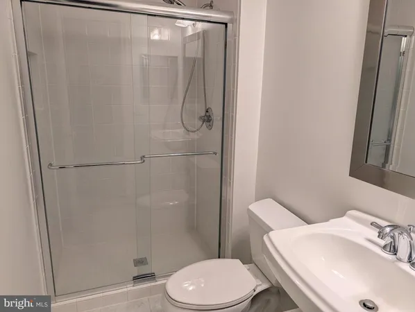 a white toilet sitting next to a bathroom sink