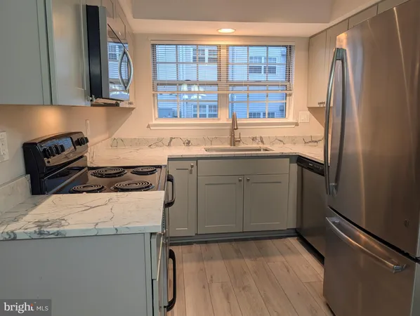 a kitchen with a sink a stove and refrigerator