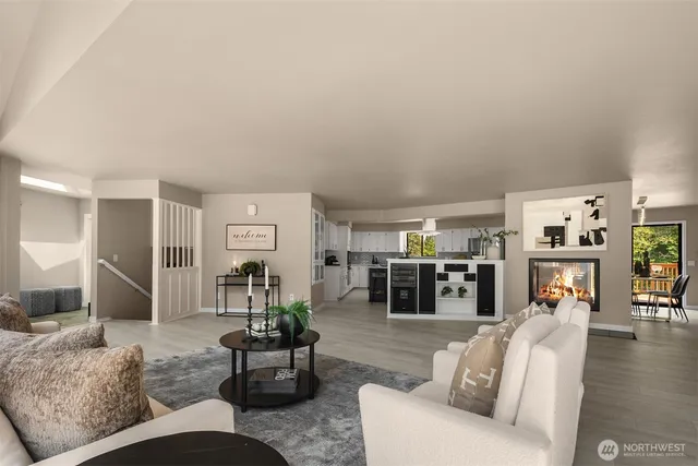 a living room with furniture and view of kitchen