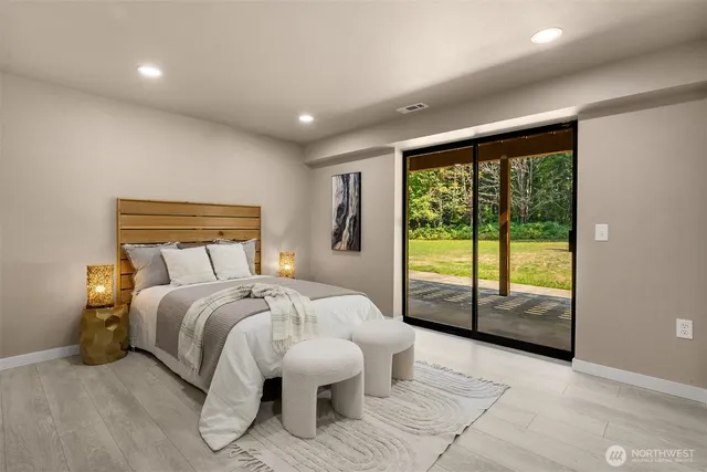 a bedroom with a large bed and a large window