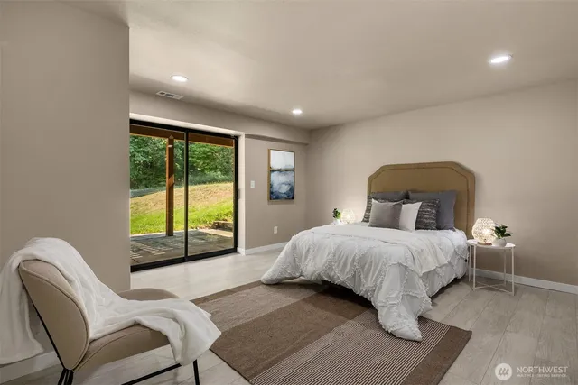 a bedroom with a bed and a large window