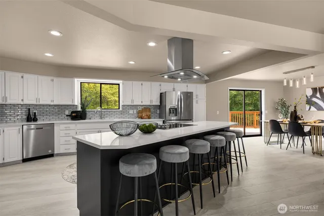a kitchen with kitchen island granite countertop a table and chairs in it