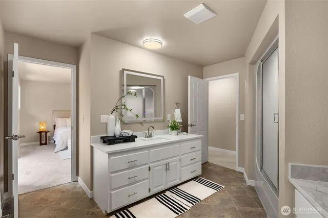 a bathroom with a double vanity sink and a mirror