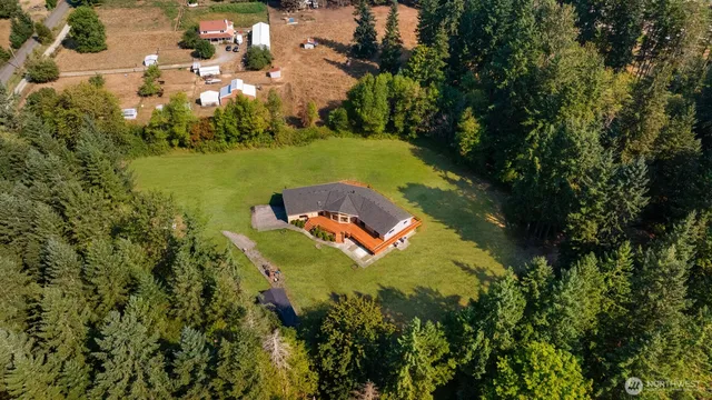 an aerial view of a house with a yard swimming pool outdoor seating and yard