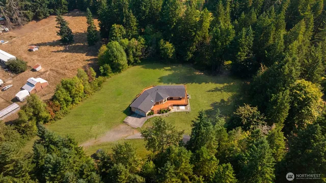 an aerial view of a house with a yard basket ball court and outdoor seating