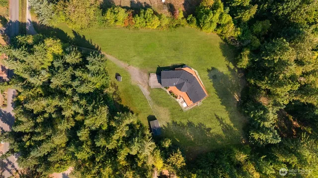 an aerial view of a residential houses with outdoor space