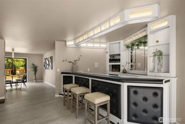 a kitchen with a table chairs refrigerator and cabinets