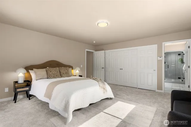 a spacious bedroom with a bed and a couch