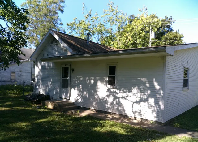 a front view of a house with a yard garage and outdoor seating