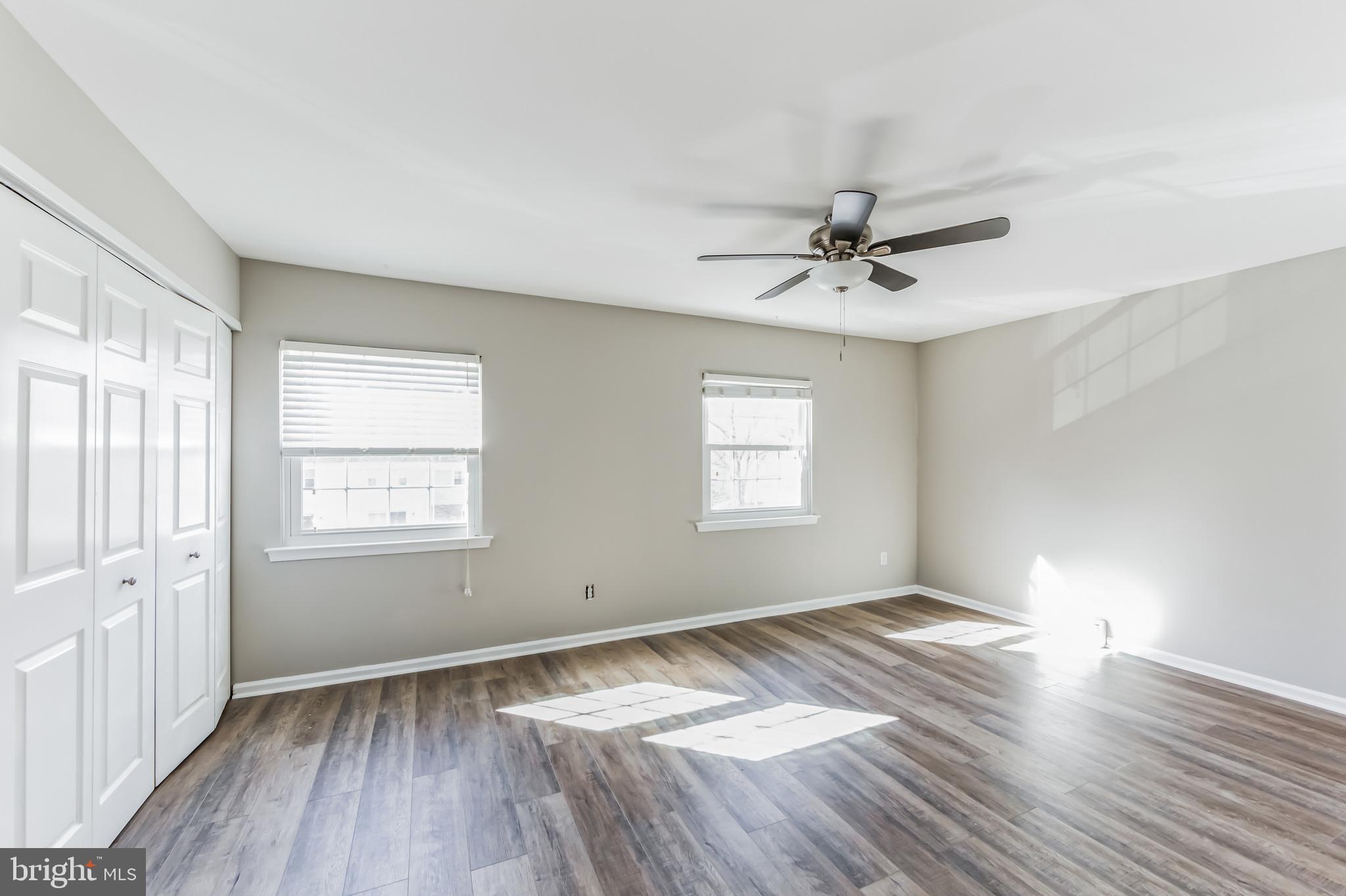 357 Saybrook Lane, Unit 158 Wallingford, PA 19086 - Photo 14 of 18 wooden floor in an empty room with a window