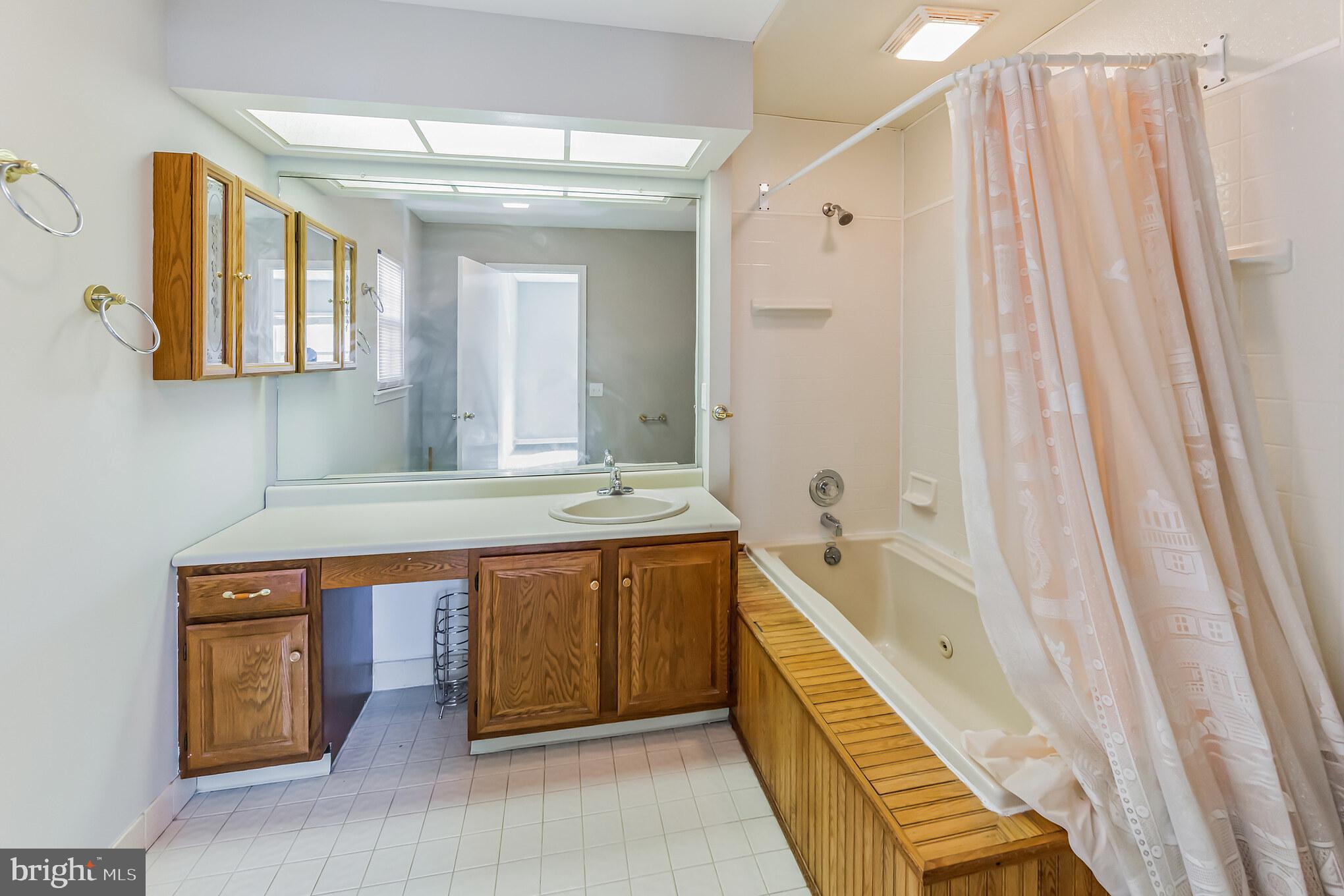 357 Saybrook Lane, Unit 158 Wallingford, PA 19086 - Photo 15 of 18 a spacious bathroom with a double vanity sink and a bathtub