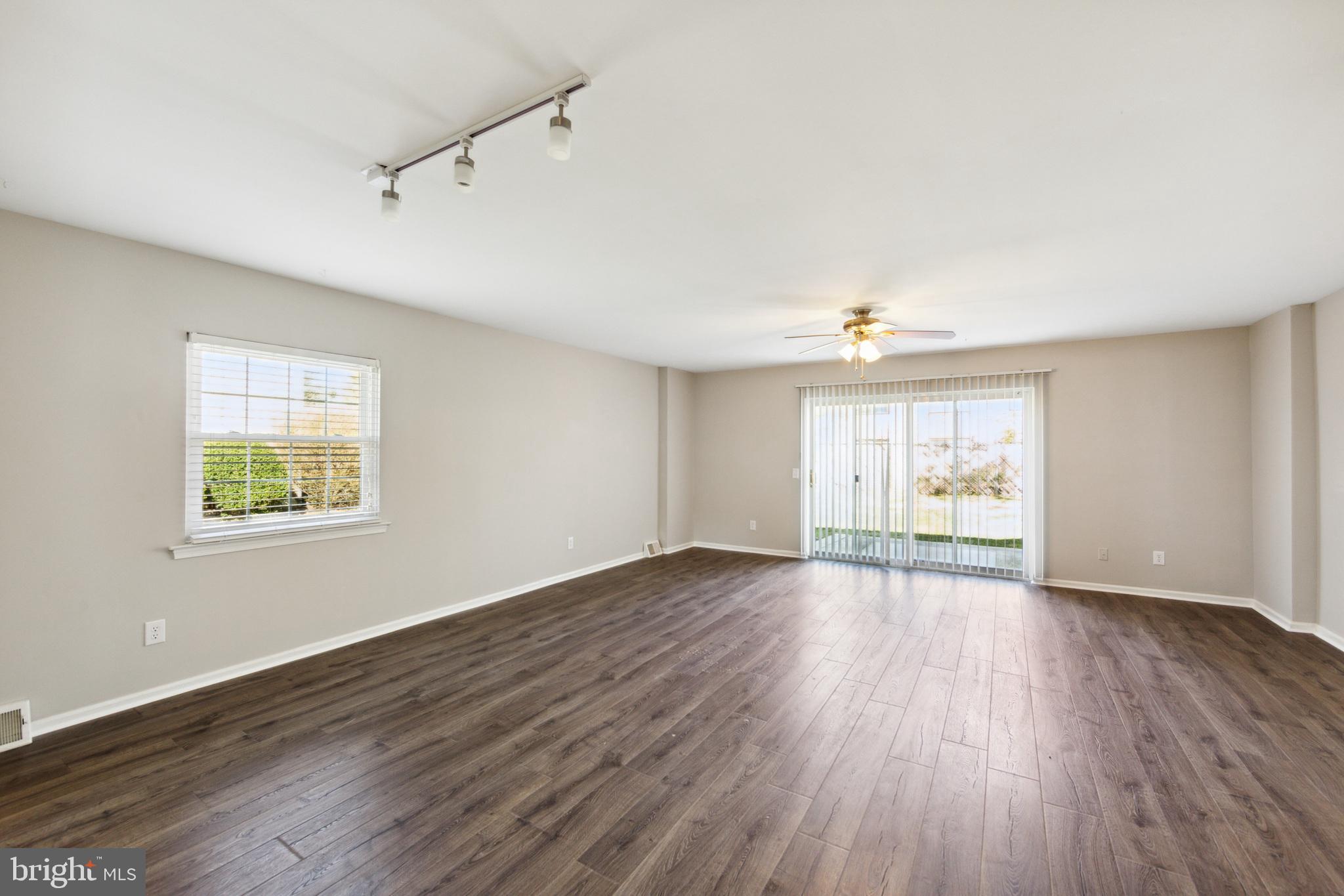 357 Saybrook Lane, Unit 158 Wallingford, PA 19086 - Photo 2 of 18 a view of an empty room with wooden floor and a window