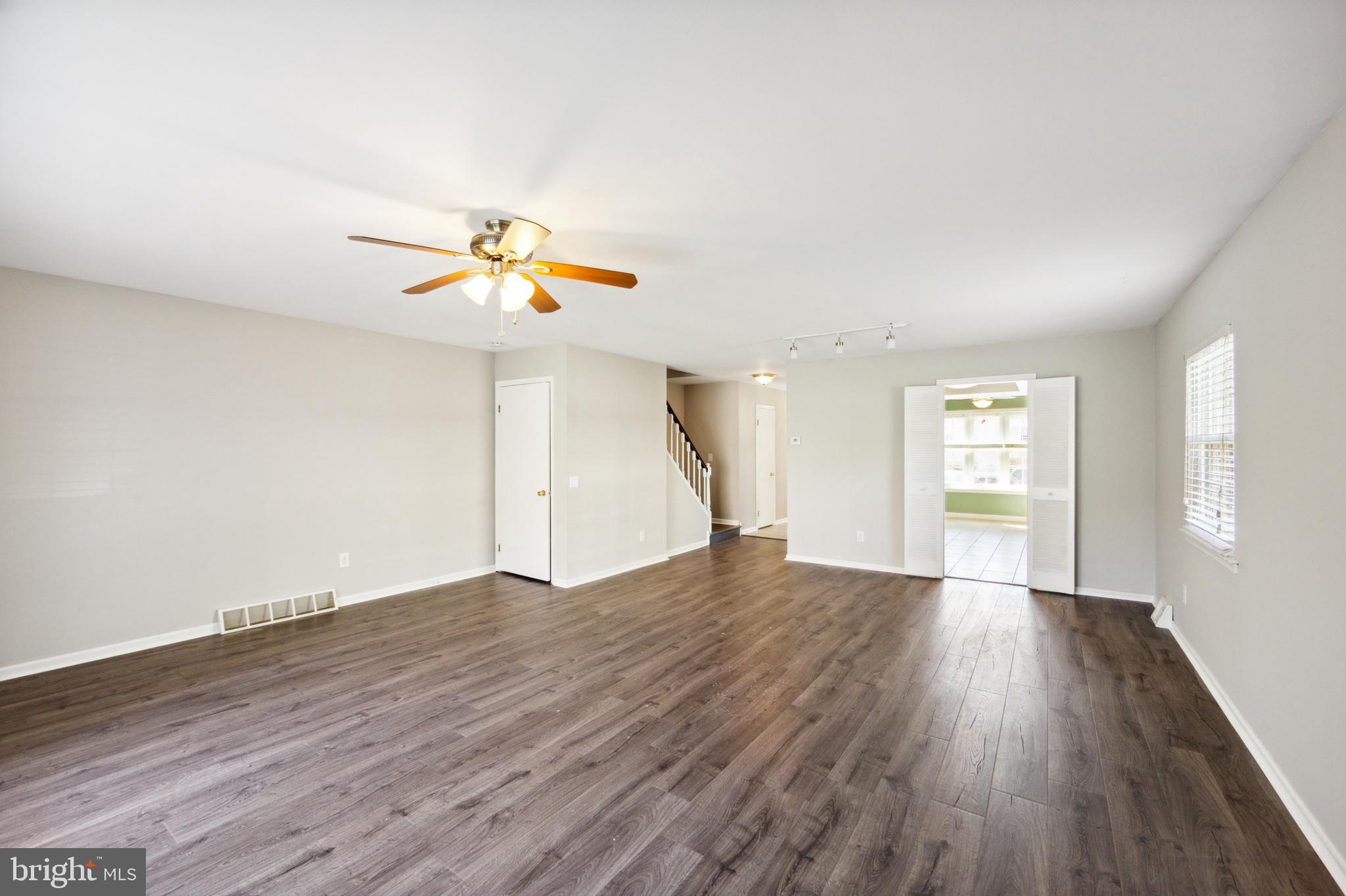 357 Saybrook Lane, Unit 158 Wallingford, PA 19086 - Photo 3 of 18 wooden floor in an empty room with a window