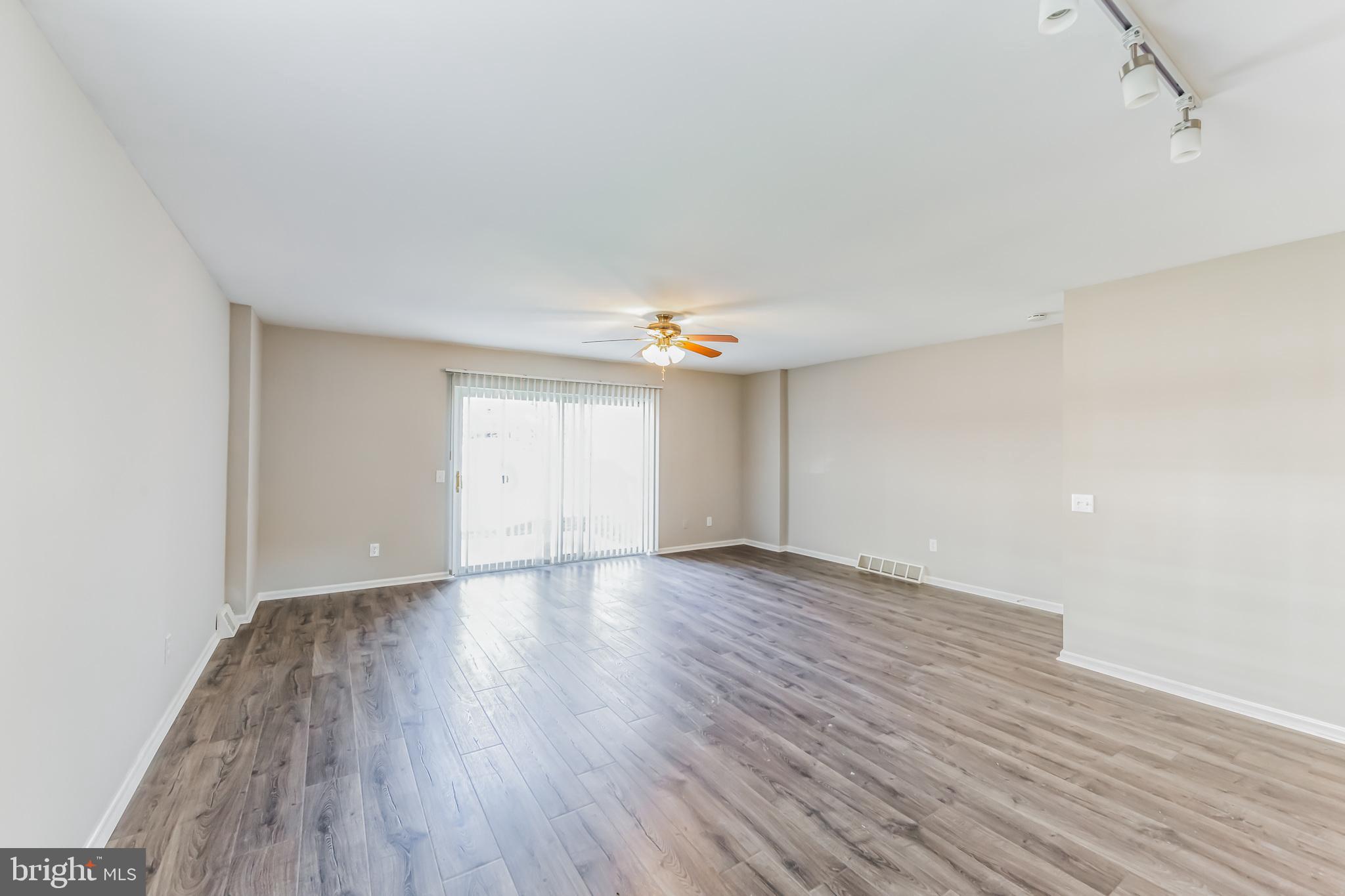 357 Saybrook Lane, Unit 158 Wallingford, PA 19086 - Photo 8 of 18 wooden floor in an empty room with a window