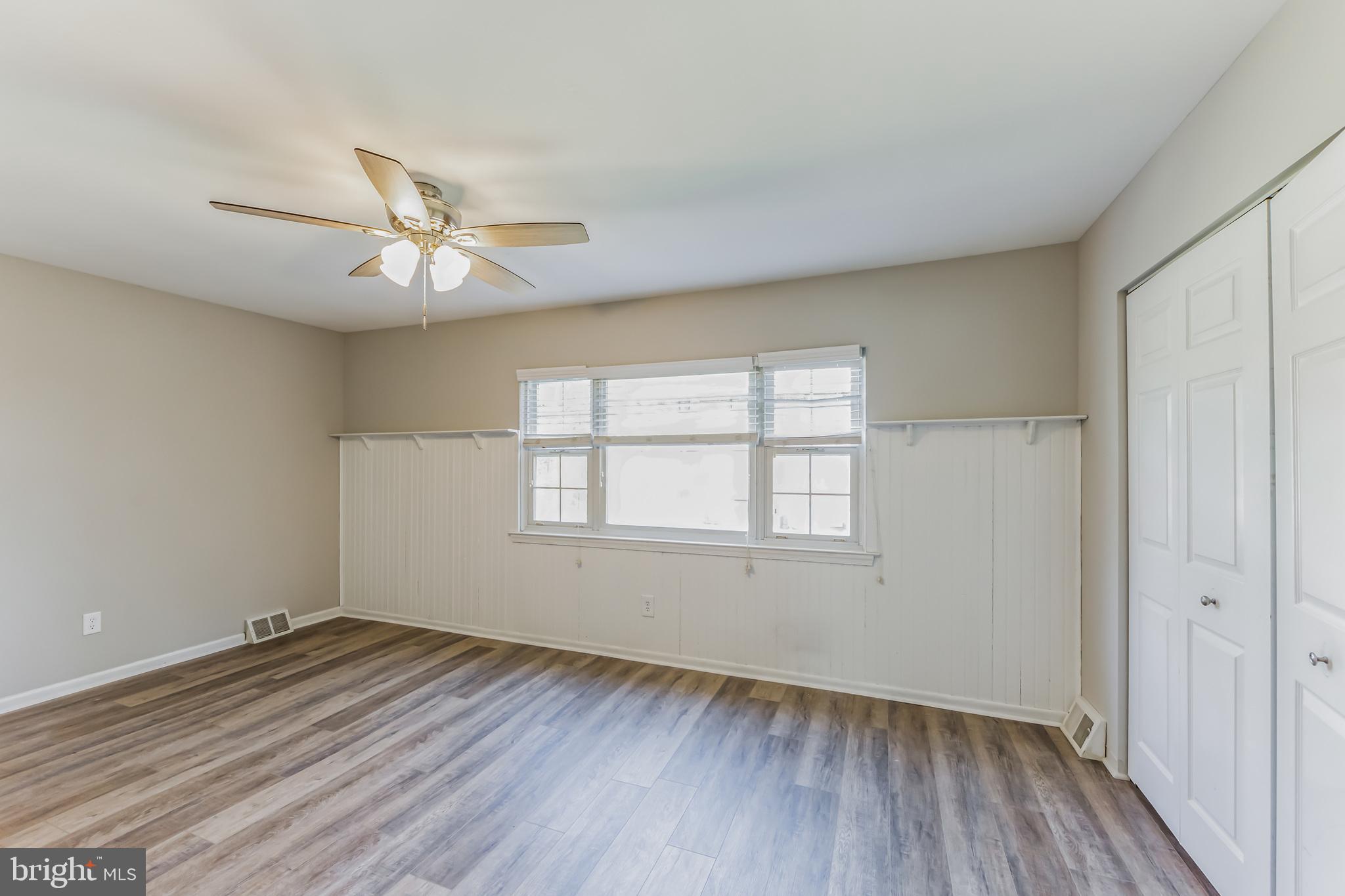 357 Saybrook Lane, Unit 158 Wallingford, PA 19086 - Photo 10 of 18 wooden floor in an empty room with a window