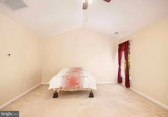a bedroom with a large bed mirror and a window