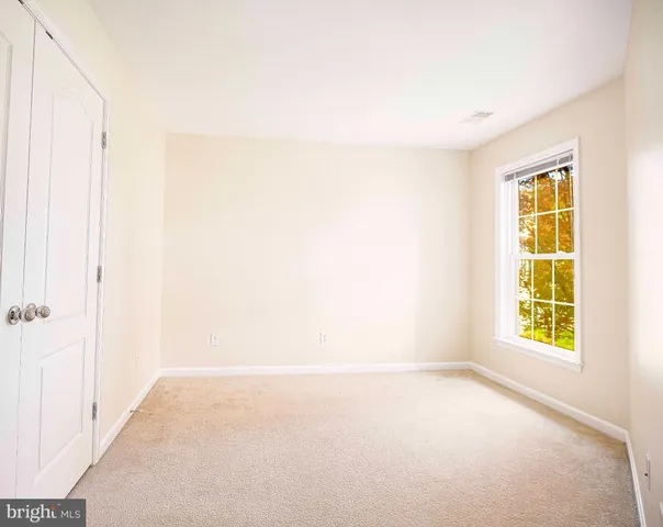 an empty room with a empty space and a window