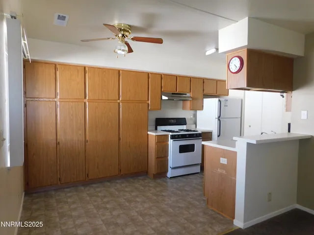 a kitchen with refrigerator cabinets and a ceiling fan