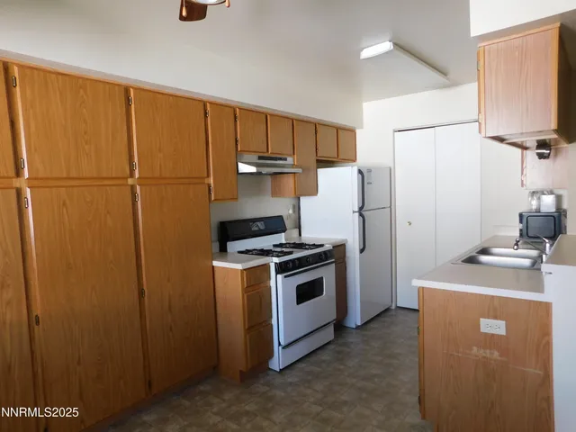 a kitchen with a stove and a refrigerator