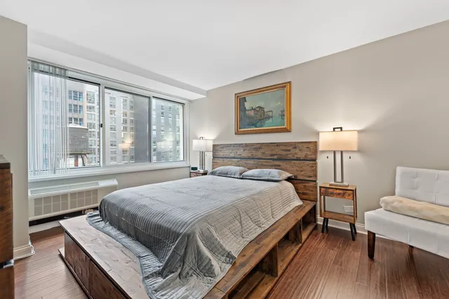 a bedroom with a bed and a painting on the wall