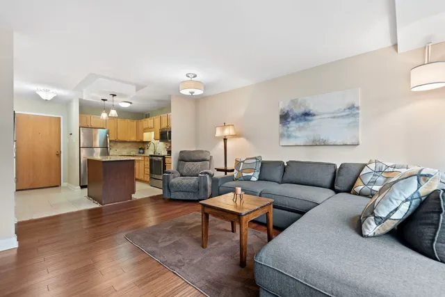 a living room with furniture kitchen view and a table