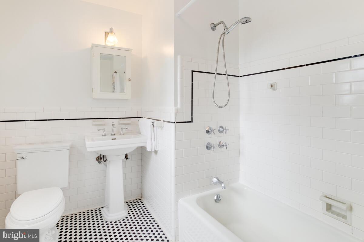 813 Kingston Road Baltimore, MD 21212 - Photo 42 of 55 Hallway full bathroom in black and white