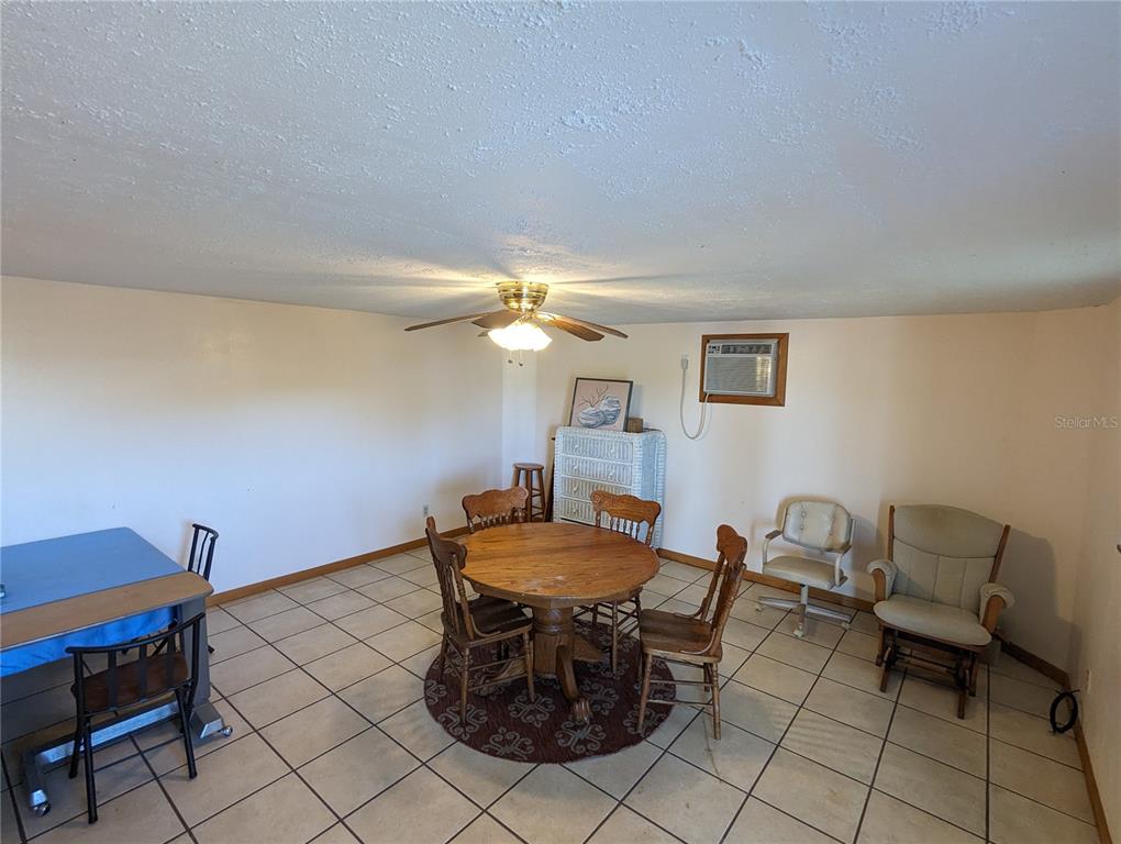 16070 Carlton Lake Road Wimauma, FL 33598 - Photo 6 of 10 a view of a dining room with furniture and a table chair