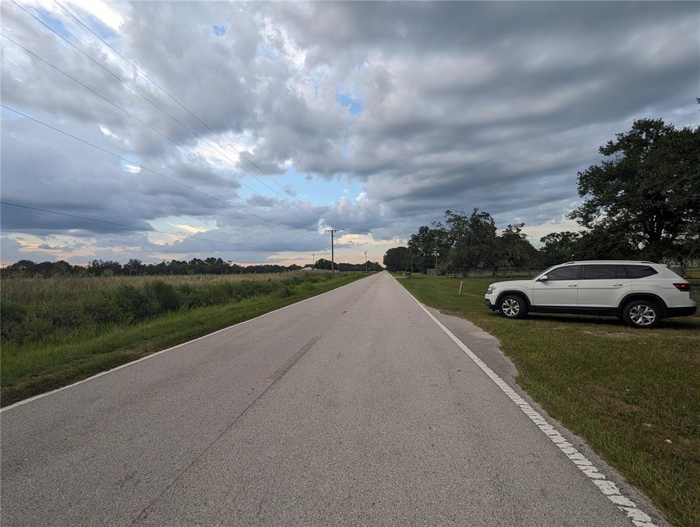 16070 Carlton Lake Road Wimauma, FL 33598 - Photo 10 of 10 a view of a street with a car parked on the side of the road