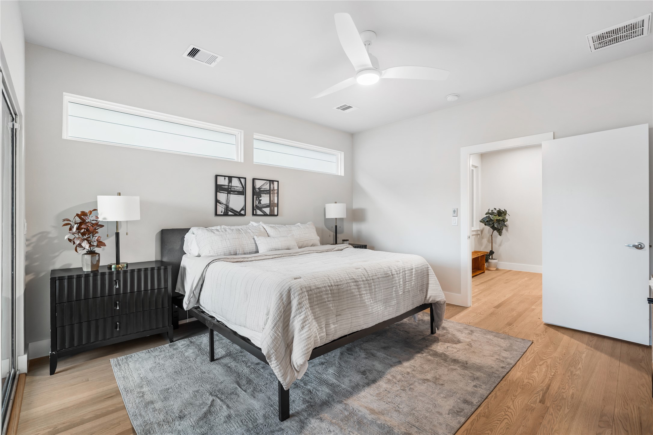 1912 Erastus Street Houston, TX 77020 - Photo 16 of 29 The spacious primary suite is thoughtfully set apart from the secondary bedrooms, offering a quiet retreat filled with natural light & serene comfort.