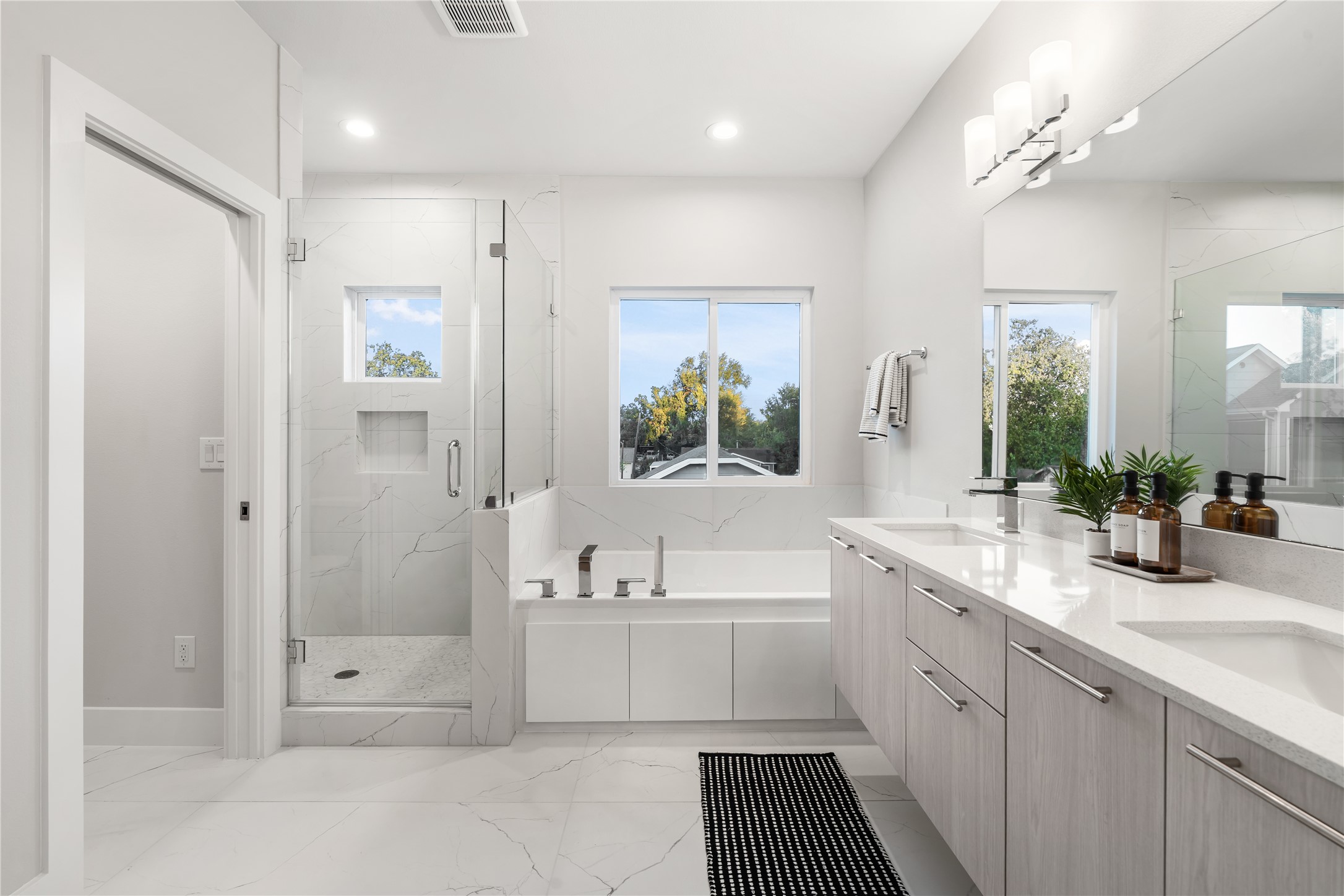 1912 Erastus Street Houston, TX 77020 - Photo 18 of 29 The primary ensuite feels bright and airy, featuring custom windows that fill the space with natural light and highlight the sleek, modern finishes throughout.
