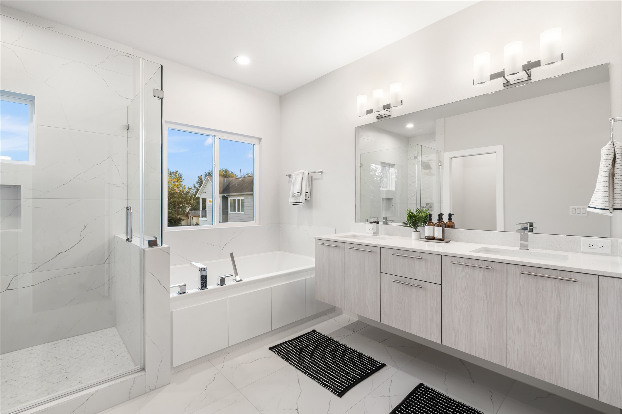 1912 Erastus Street Houston, TX 77020 - Photo 19 of 29 Dual floating vanities provide generous storage and are paired with a large framed mirror and sleek modern fixtures, creating a spa-like atmosphere you’ll love starting and ending your day in.